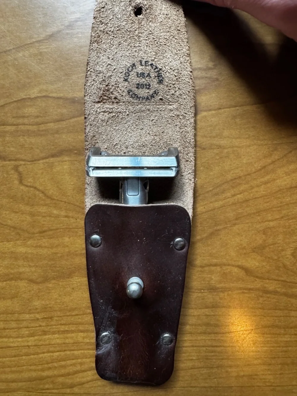 OneBlade razor with leather case, metal stand, and blades